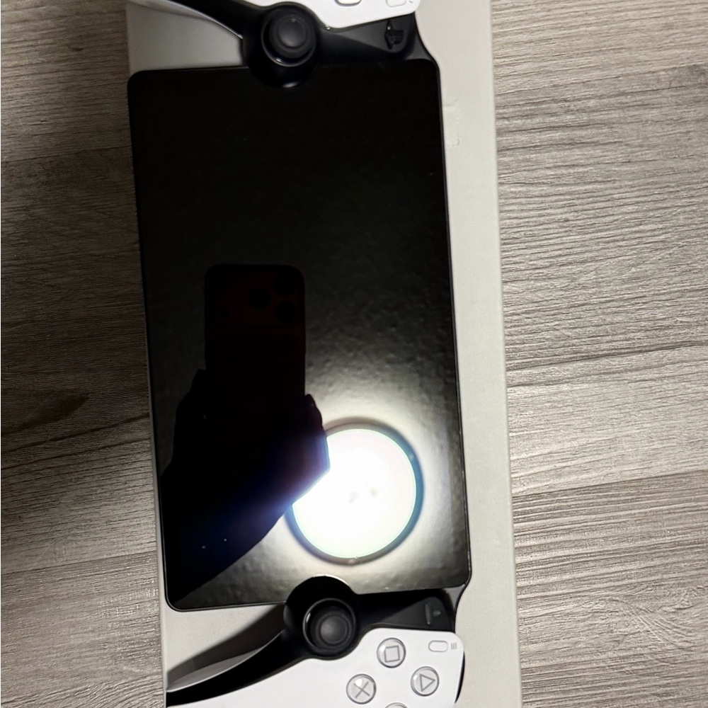 Sony Handheld Console - Black Screen with White Controls